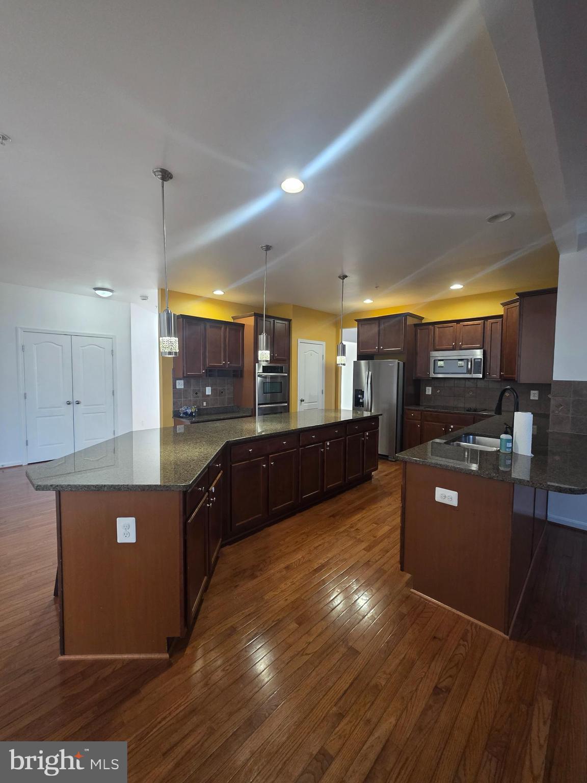 2409 Barrett Court Frederick, MD 21702 - Photo 13 of 19 a large kitchen with stainless steel appliances and a large counter top