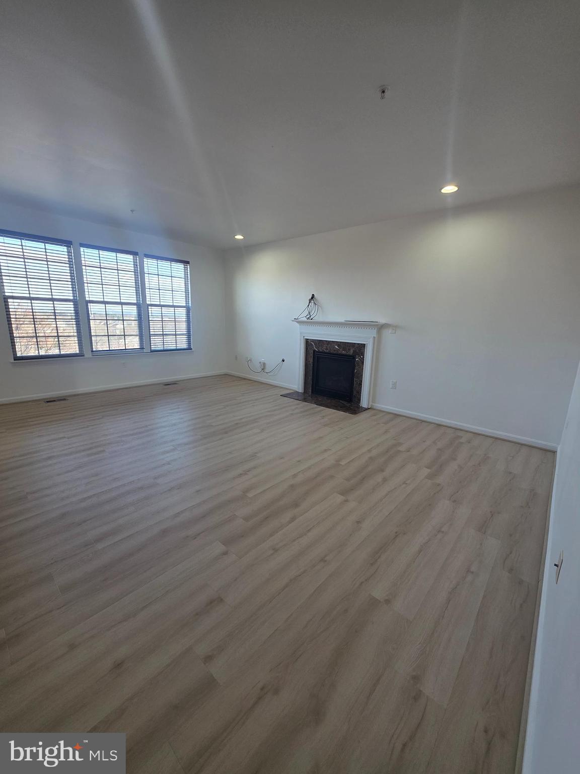 2409 Barrett Court Frederick, MD 21702 - Photo 19 of 19 an empty room with wooden floor and windows