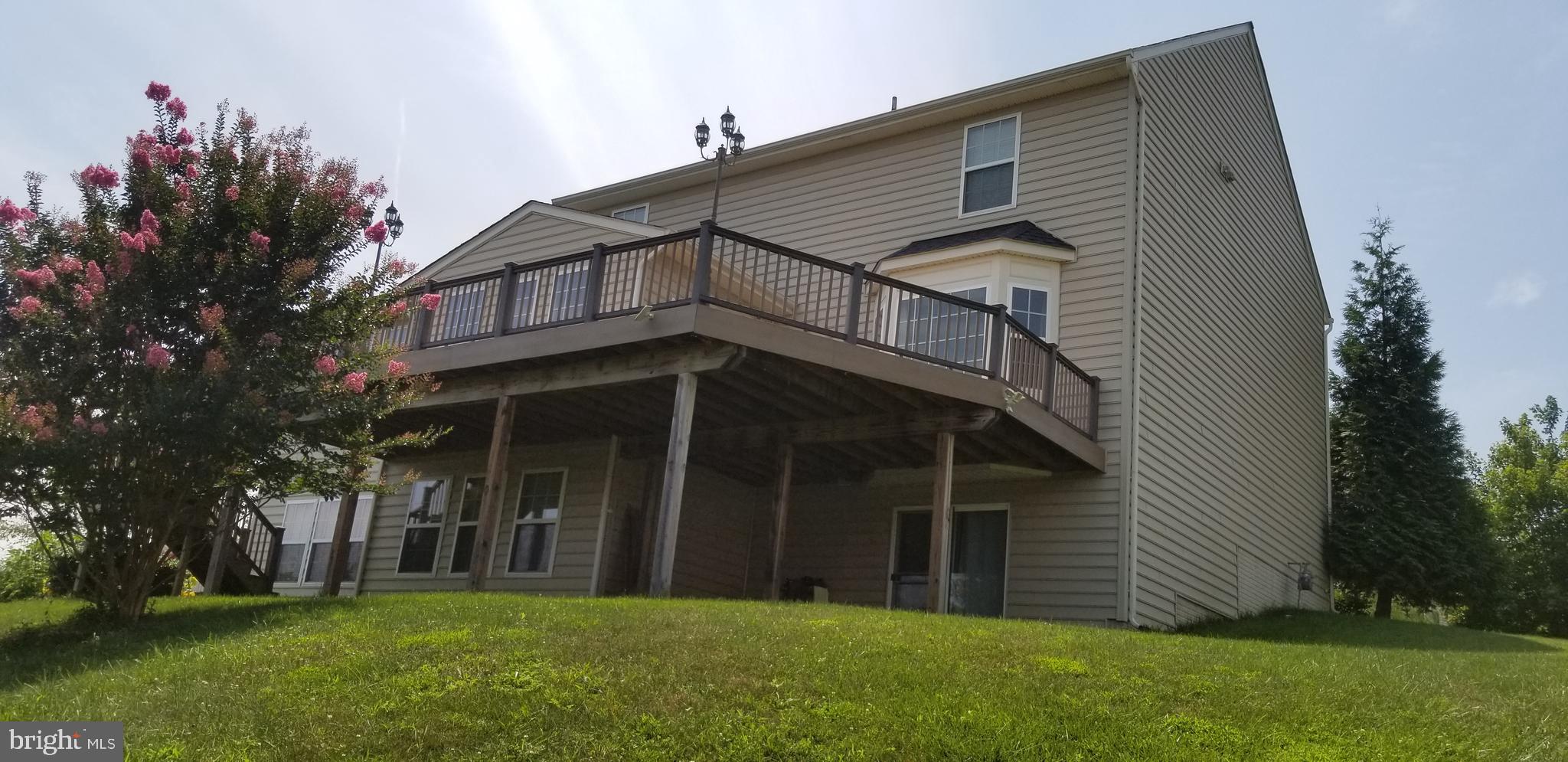 2409 Barrett Court Frederick, MD 21702 - Photo 3 of 19 a front view of a house with a garden