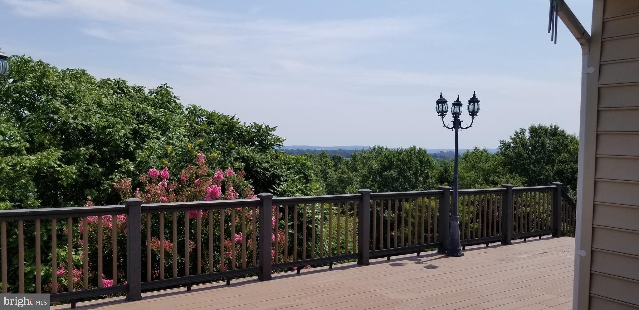 2409 Barrett Court Frederick, MD 21702 - Photo 4 of 19 a view of a balcony with wooden fence and trees
