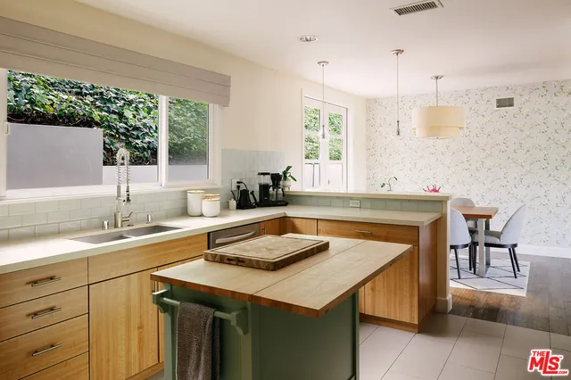 a kitchen with a sink a stove and a refrigerator