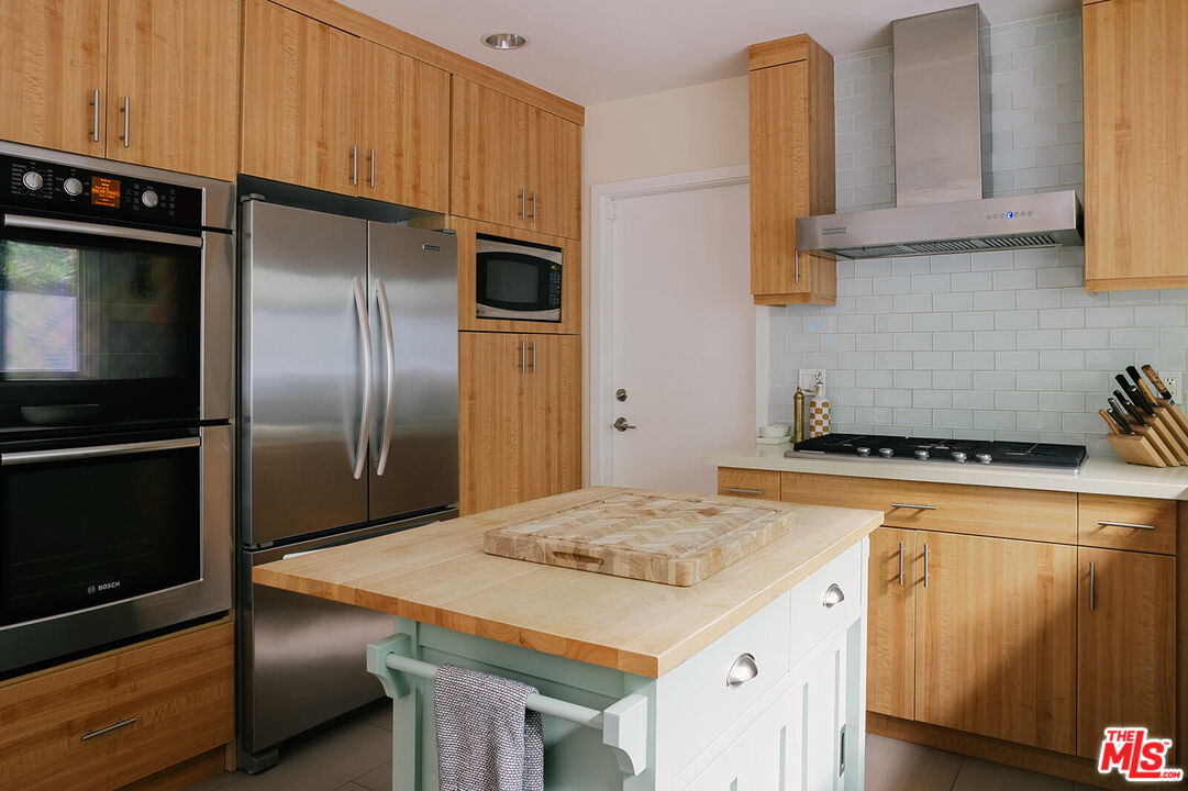 3346 Coy Drive Sherman Oaks, CA 91423 - Photo 14 of 41 a kitchen with stainless steel appliances granite countertop a refrigerator a stove and a sink