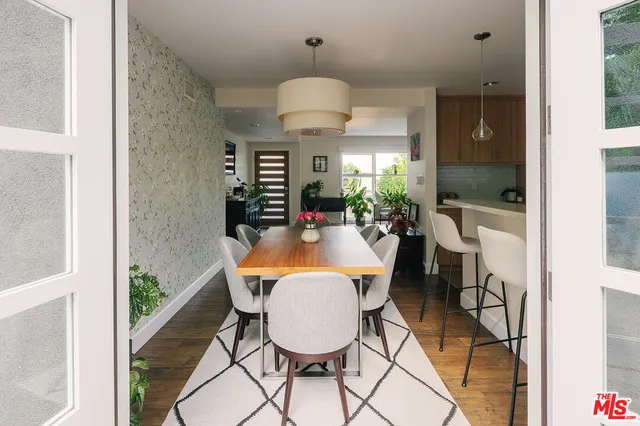 a dining room with furniture and a chandelier