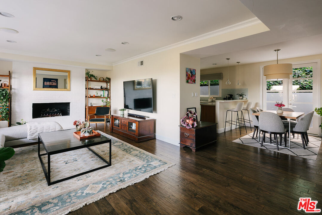 3346 Coy Drive Sherman Oaks, CA 91423 - Photo 5 of 41 a living room with furniture a fireplace and a flat screen tv