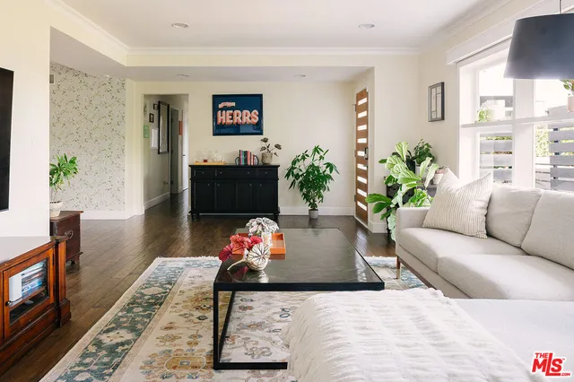 a living room with furniture and flowers