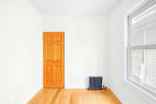 a room with a window and wooden floor