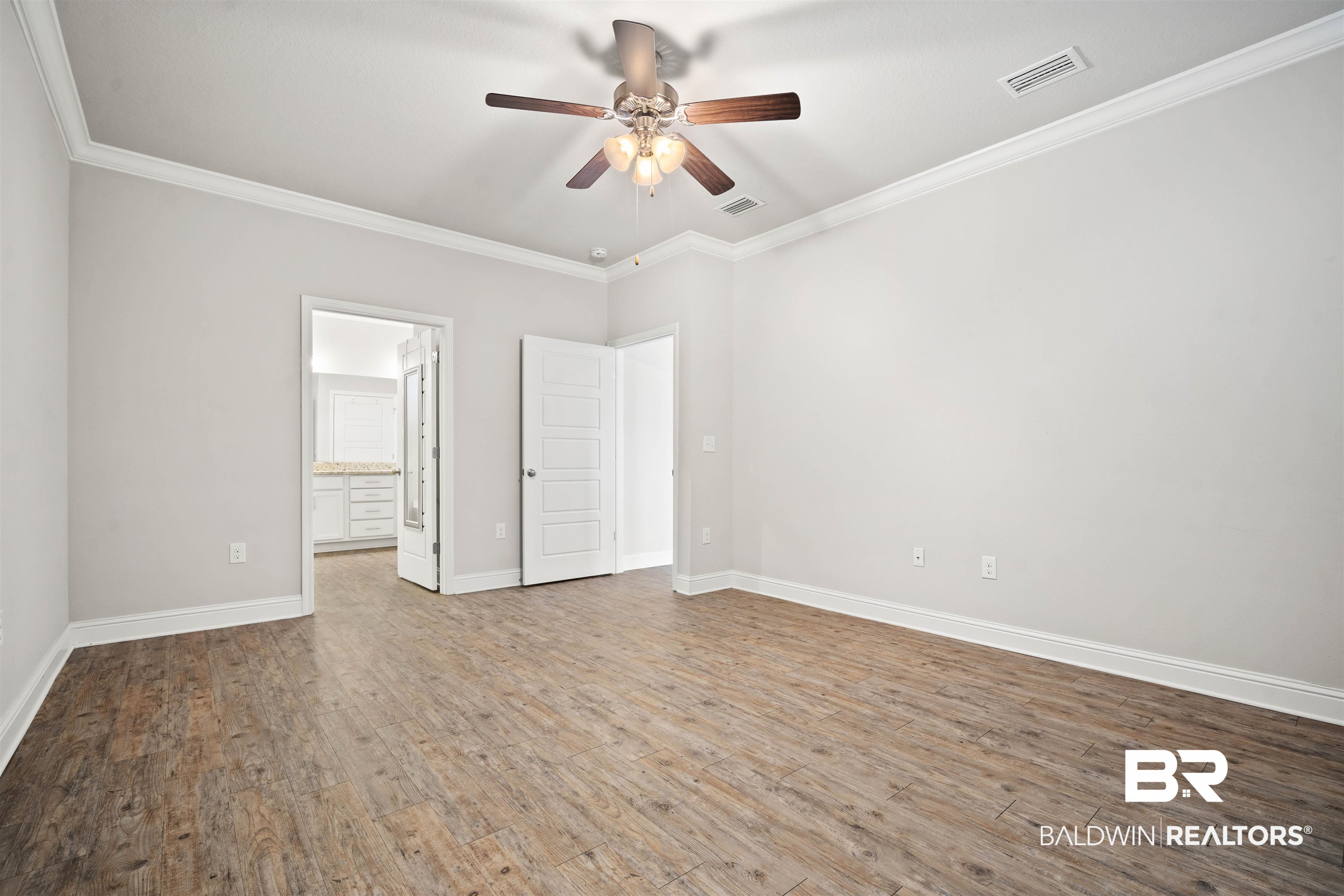 24479 Kipling Court Daphne, AL 36526 - Photo 14 of 41 Unfurnished bedroom with crown molding, wood finished floors, ceiling fan, and ensuite bath