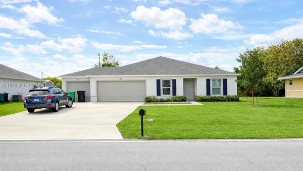a front view of a house with a garden and pathway