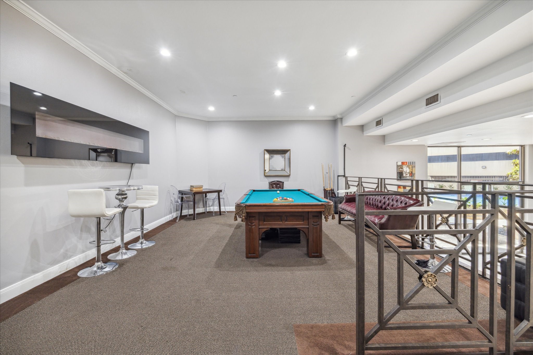 3350 McCue Road, Unit 2201 Houston, TX 77056 - Photo 24 of 27 RESIDENT'S LOUNGE - The lofted part of the Resident's Lounge is equipped with a classic pool table and comfortable seating.