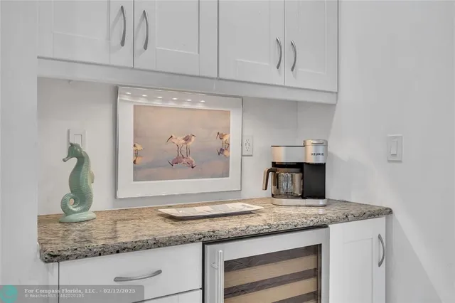 a kitchen with granite countertop a sink and a stove