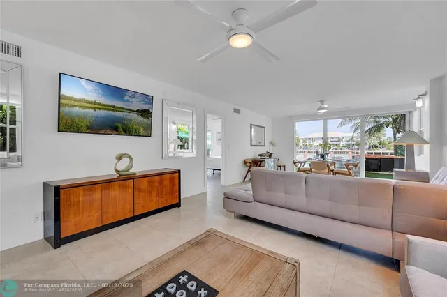 a dining room with furniture and a floor to ceiling window