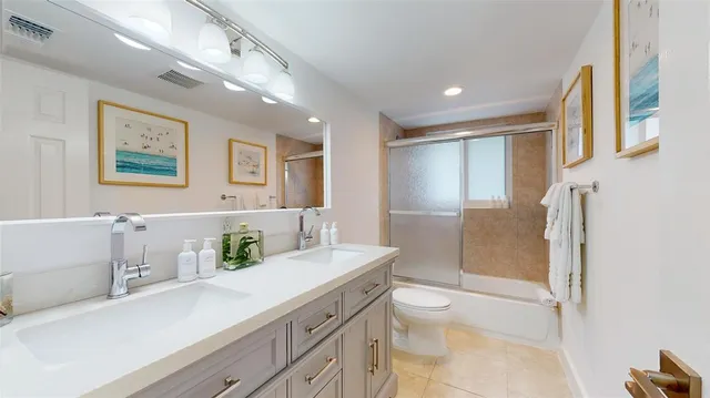 a large bedroom with a large bed and large mirror