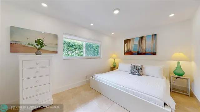 a bedroom with a bed and a view of living room