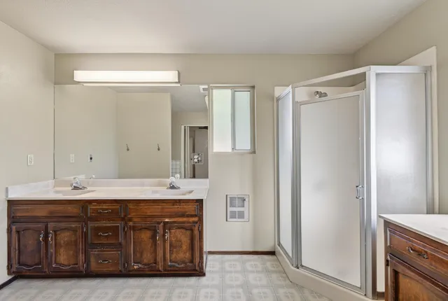 a bathroom with a sink double vanity and a mirror