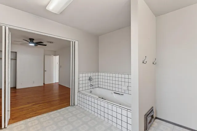 a bathroom with a bathtub and shower