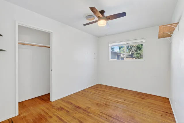 a view of empty room with wooden floor