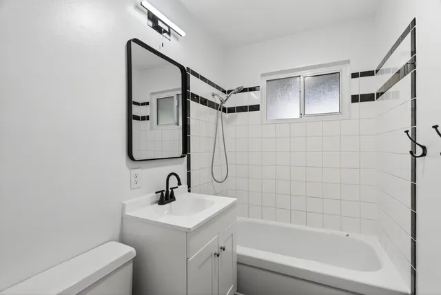 a bathroom with a sink toilet and shower