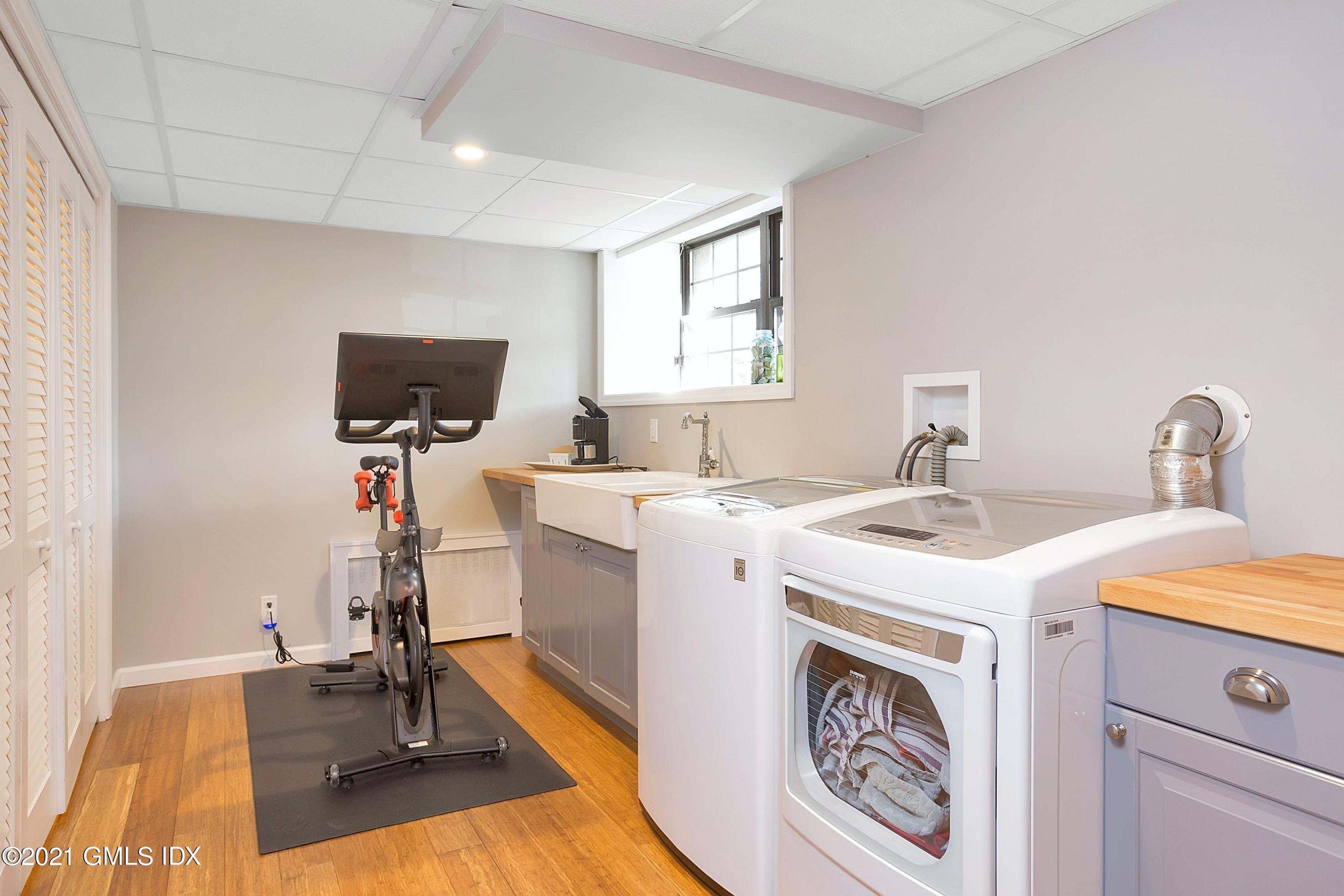 24 Valleywood Road Cos Cob, CT 06830 - Photo 18 of 24 a utility room with cabinets washer and dryer