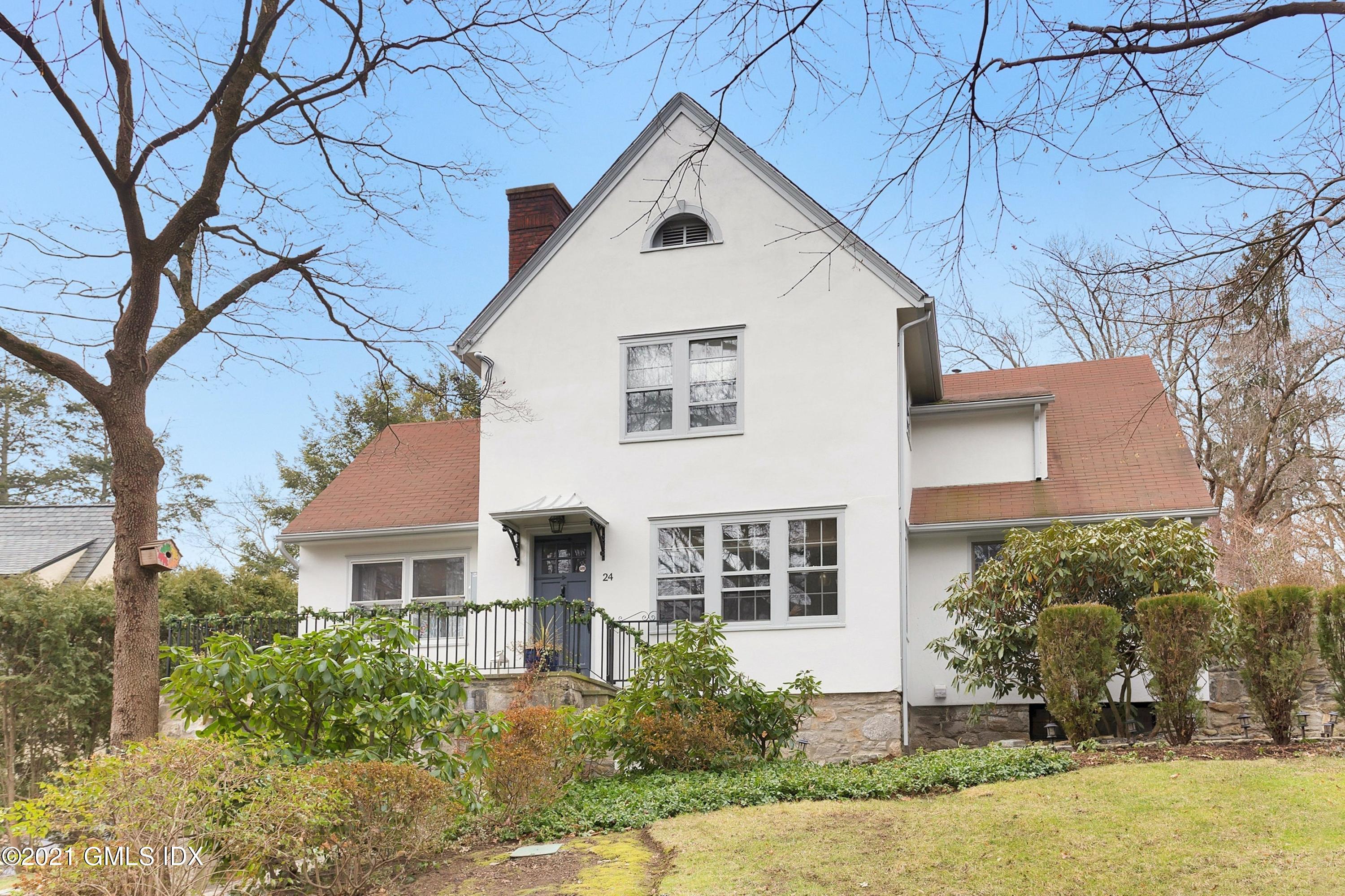 24 Valleywood Road Cos Cob, CT 06830 - Photo 2 of 24 a view of a white house next to a yard with big trees