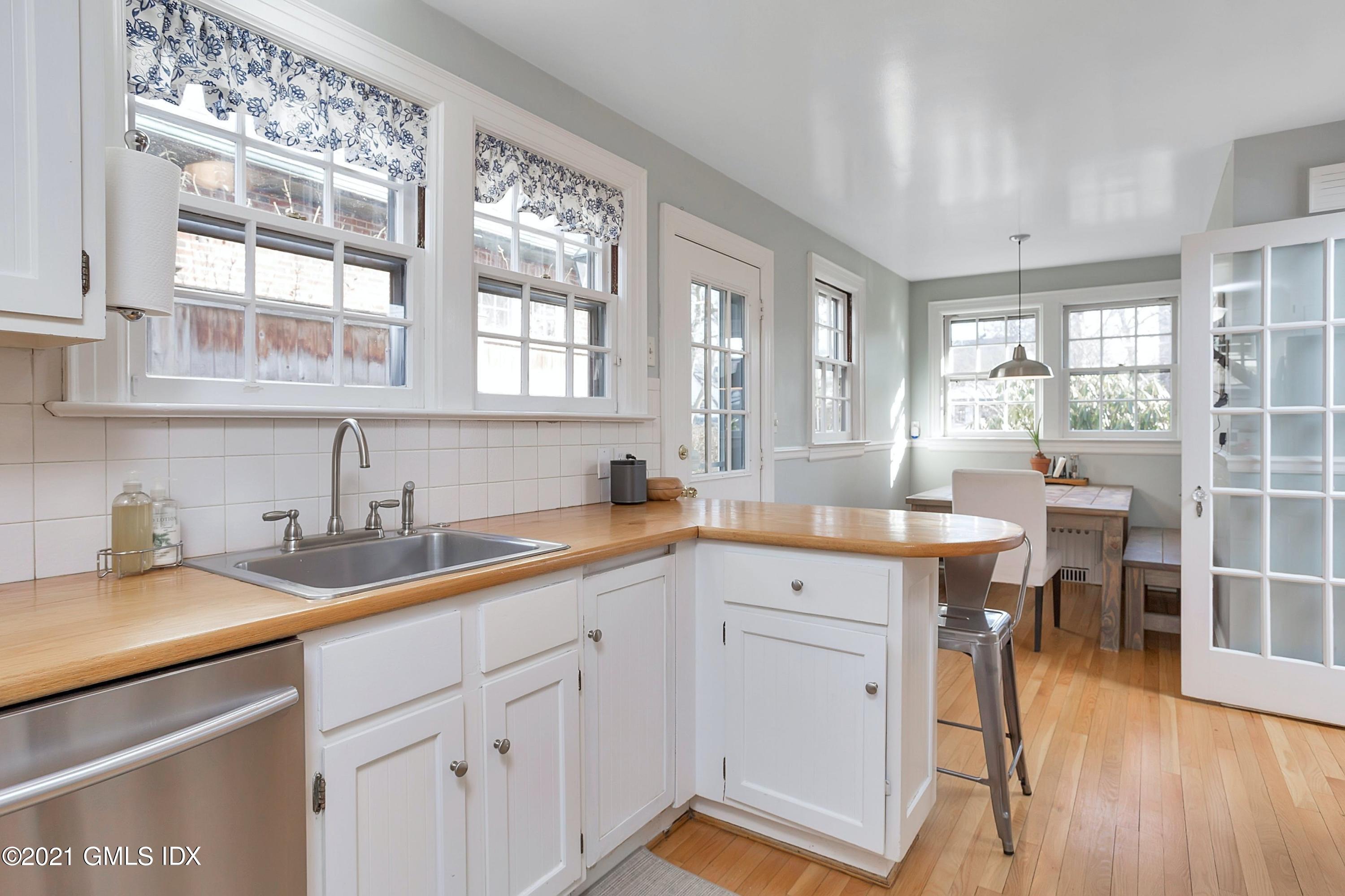 24 Valleywood Road Cos Cob, CT 06830 - Photo 3 of 24 a kitchen with a sink stove and cabinets