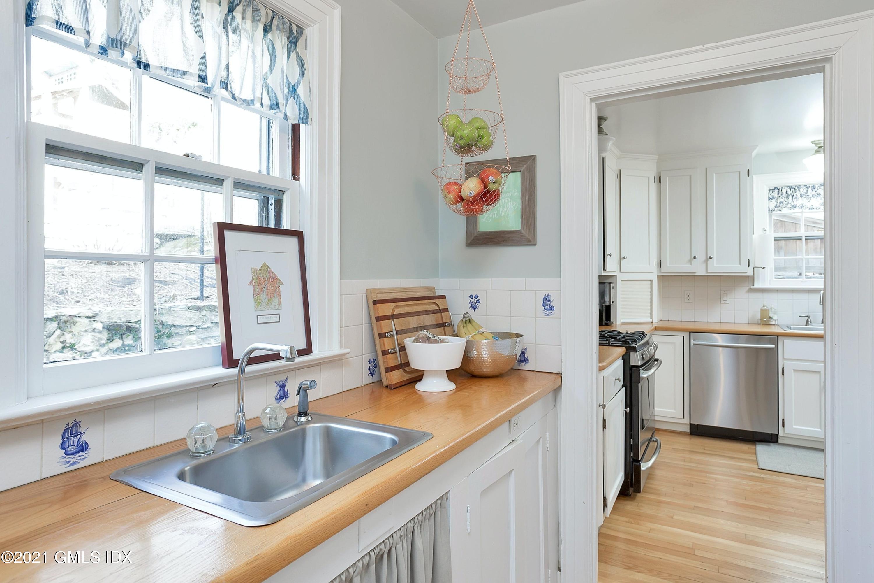 24 Valleywood Road Cos Cob, CT 06830 - Photo 6 of 24 a kitchen with a sink stove and cabinets