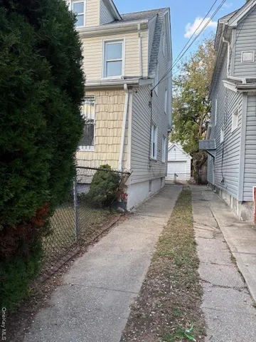 a pathway of a house with a yard