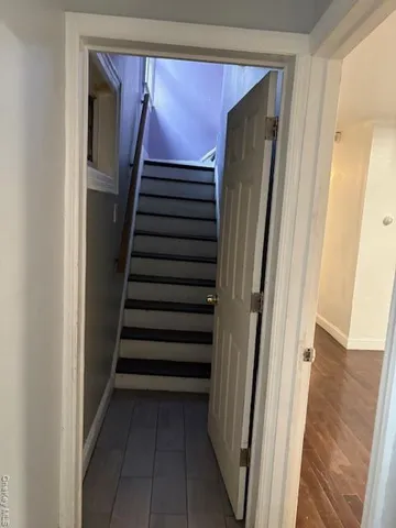 a view of staircase with wooden floor and stairs