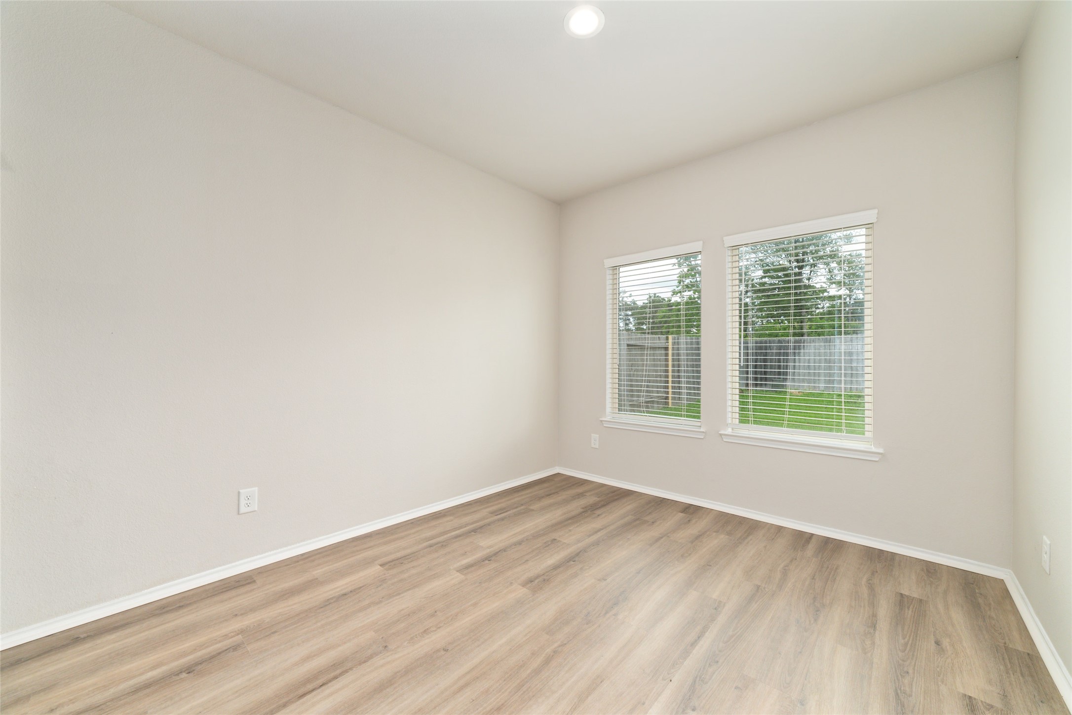 23702 Harrow Field Ln Spring Spring, TX 77373 - Photo 15 of 32 an empty room with wooden floor and windows