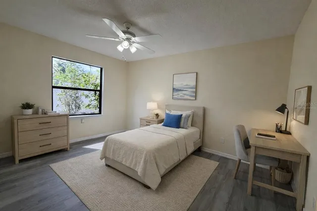 a bedroom with a bed and a window