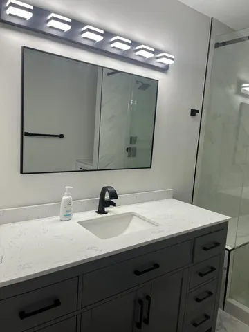 a bathroom with a sink and a mirror