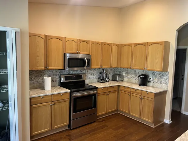 a kitchen with a sink cabinets and stainless steel appliances