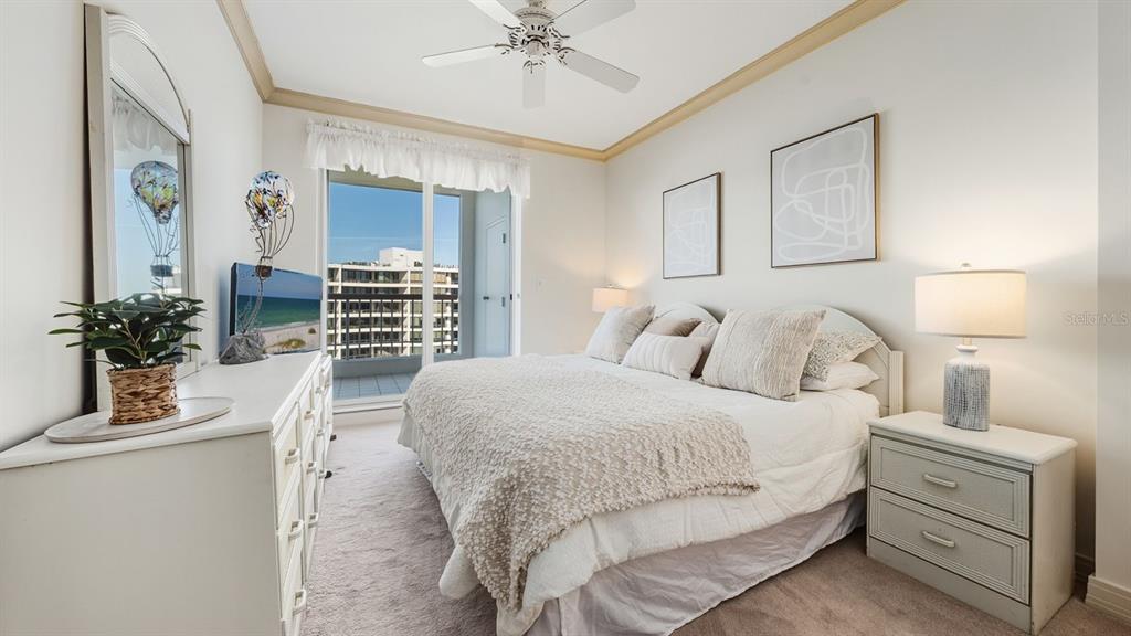 455 Longboat Club Road, Unit 707 Longboat Key, FL 34228 - Photo 39 of 69 a bedroom with a large bed and a chandelier