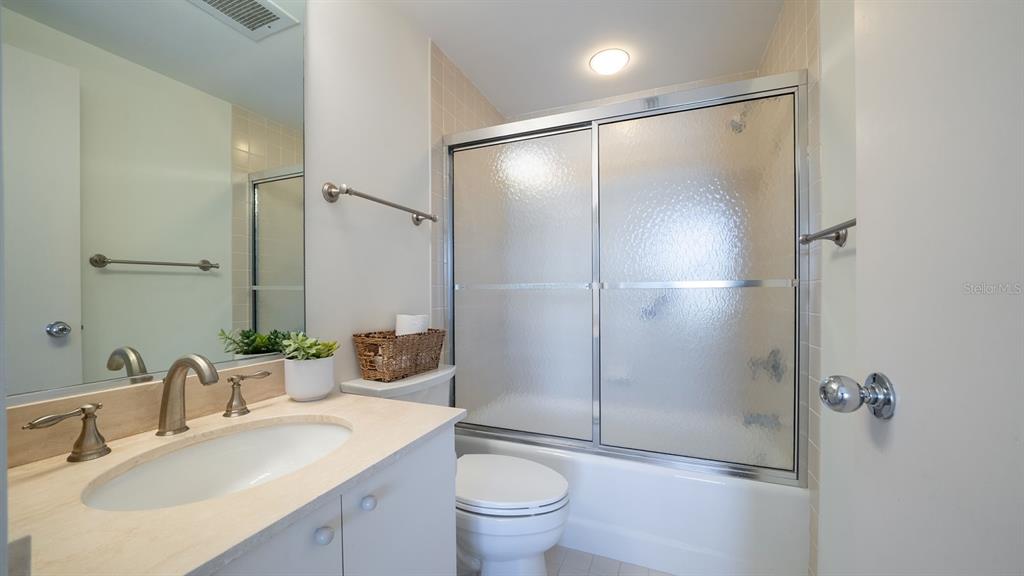 455 Longboat Club Road, Unit 707 Longboat Key, FL 34228 - Photo 40 of 69 a bathroom with a granite countertop sink toilet and shower