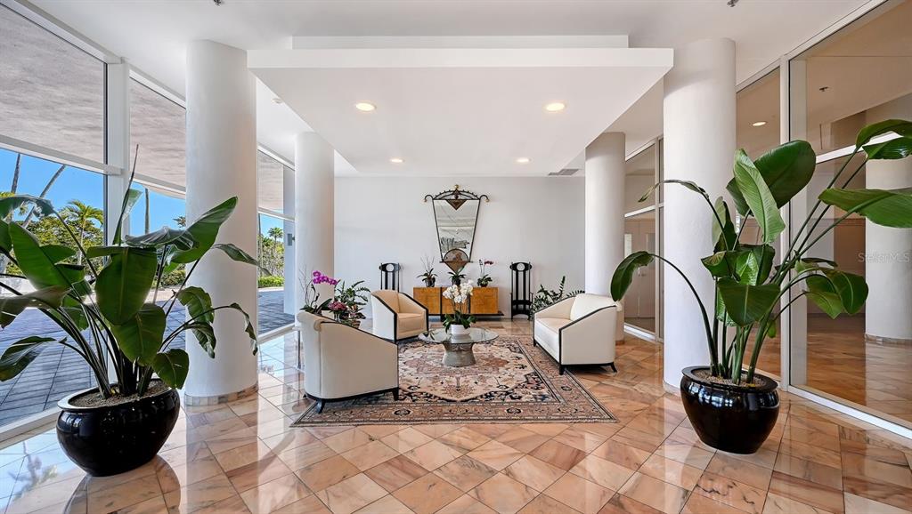 455 Longboat Club Road, Unit 707 Longboat Key, FL 34228 - Photo 7 of 69 a living room with furniture potted plant and a window