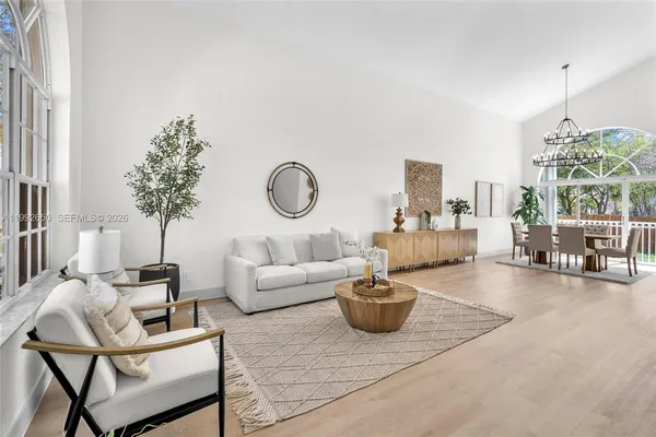 a living room with furniture and a chandelier