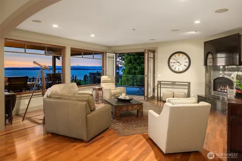 a living room with furniture a clock and a flat screen tv