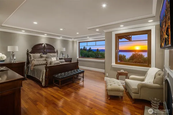 a living room with furniture a flat screen tv and floor to ceiling window