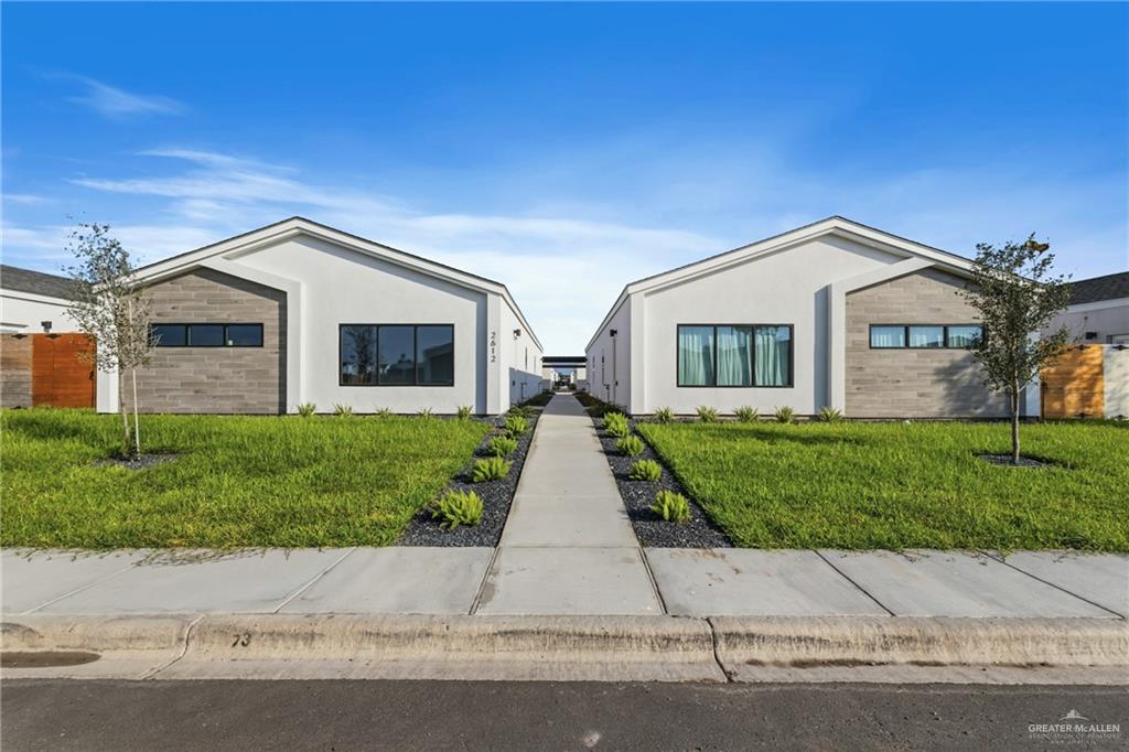 a front view of house with yard and green space
