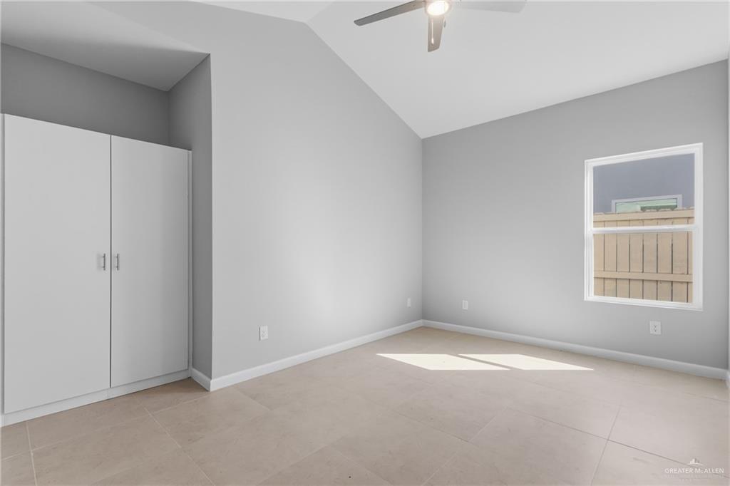 2612 Mockingbird Road, Unit 4 Weslaco, TX 78596 - Photo 6 of 11 an empty room with a window and chandelier fan