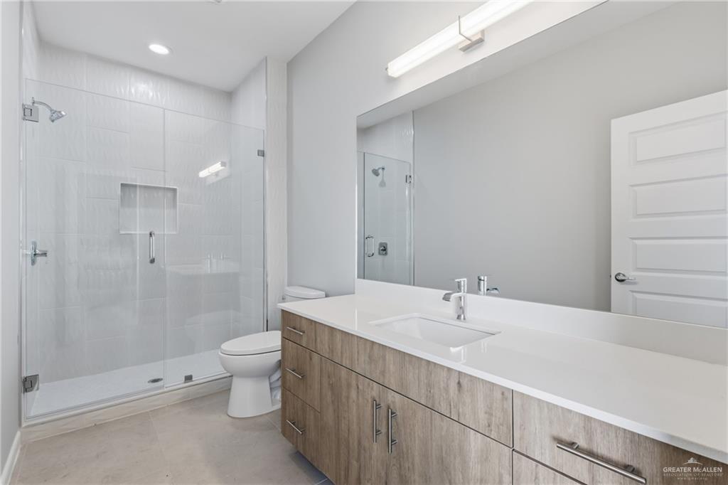 2612 Mockingbird Road, Unit 4 Weslaco, TX 78596 - Photo 10 of 11 a bathroom with a sink a toilet and shower