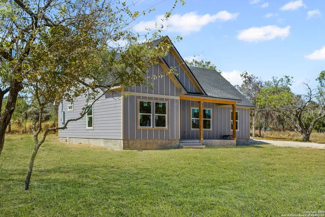 a front view of house with yard and green space
