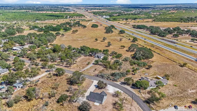 an aerial view of a house with a yard
