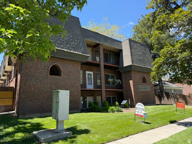 261 North 400 East, Unit 301 Provo, UT 84606 - Photo 1 of 8 Brick facade building with mansard-style roofing and private balconies