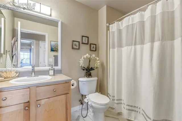 a bathroom with a toilet a sink and a mirror