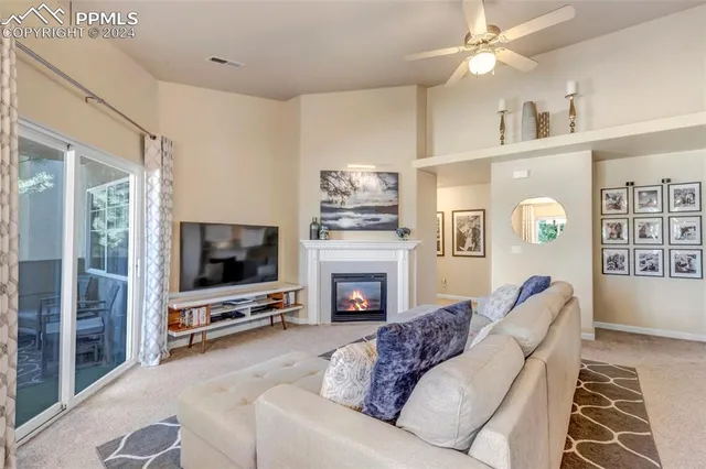 a living room with furniture flat screen tv and a fireplace