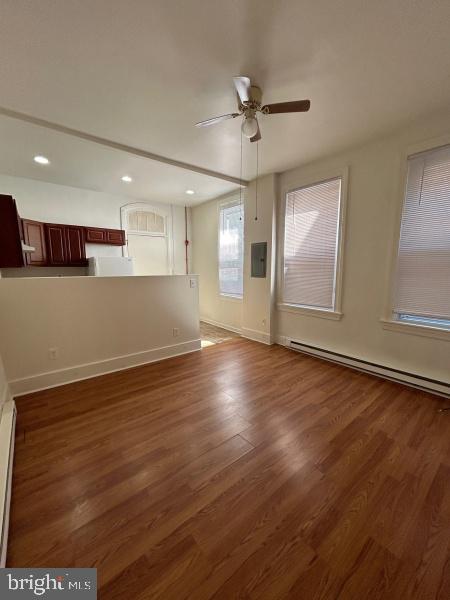 149 East Philadelphia Street, Unit A York, PA 17401 - Photo 2 of 5 an empty room with wooden floor and windows