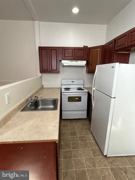 149 East Philadelphia Street, Unit A York, PA 17401 - Photo 3 of 5 a kitchen with a stove a refrigerator and a sink