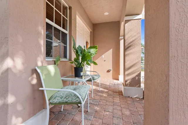 a view of a dining room with furniture and a potted plant