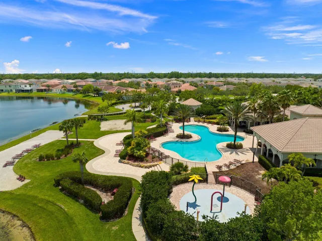 an aerial view of a house with yard swimming pool and outdoor seating