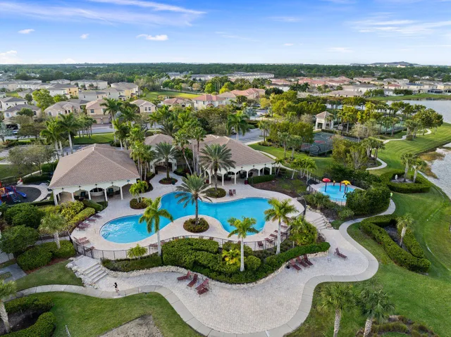 an aerial view of residential houses with outdoor space and trees